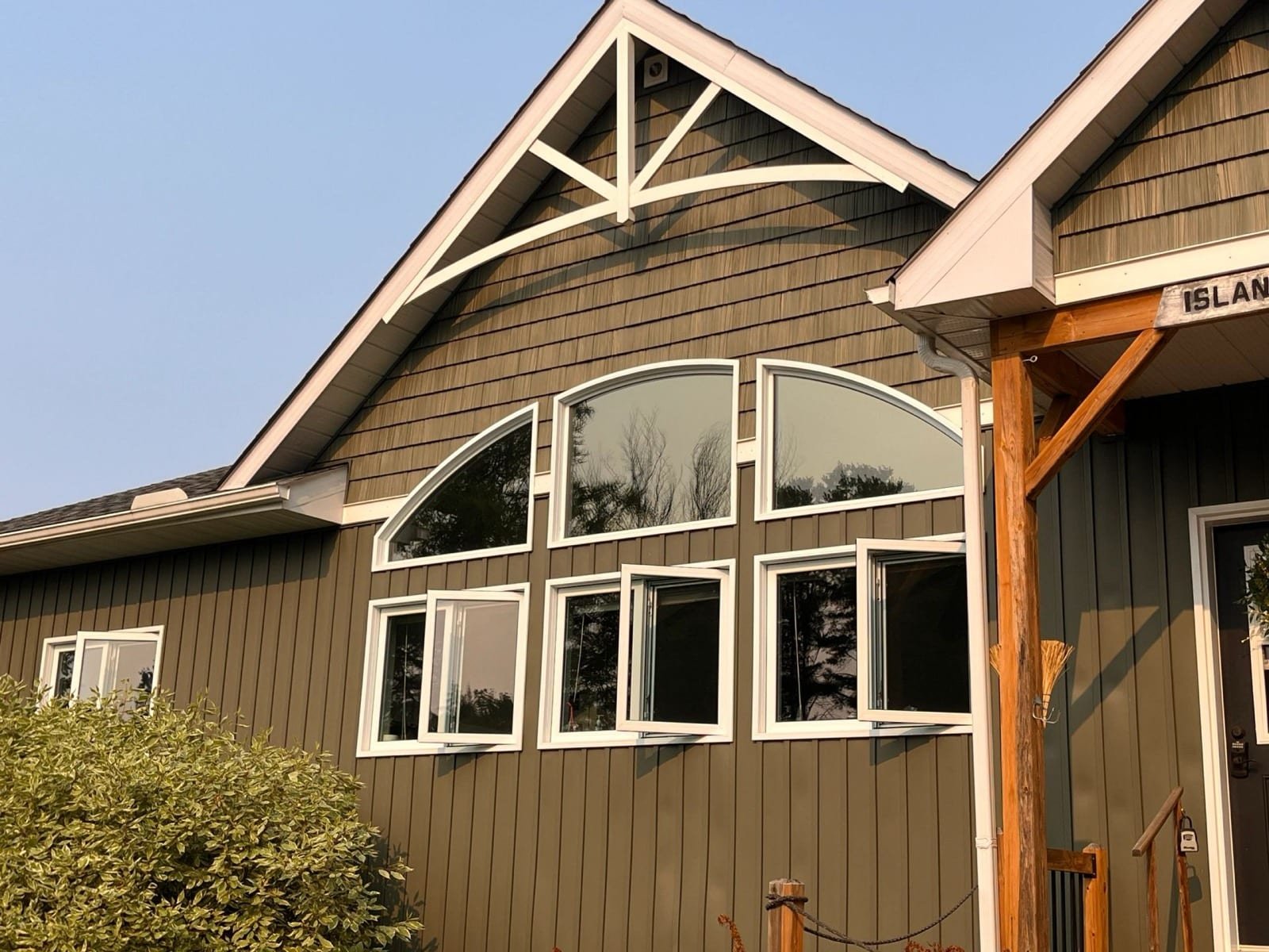Island cottage with architectural film on arched windows